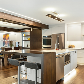 A beautiful kitchen renovation with stunning lighting, wood and furnishings.