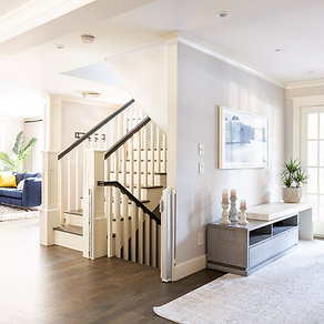 A light and bright photo of a staircase on the ground floor of a newly renovated home in Calgary, by Dependable Renovations.